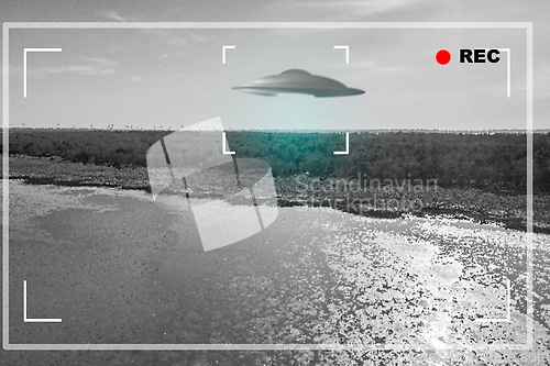 Image of UFO, alien and camera viewfinder with a spaceship flying in the gray sky over area 51 for an invasion. Camcorder, spacecraft and conspiracy with a saucer on a display to record a sighting of aliens