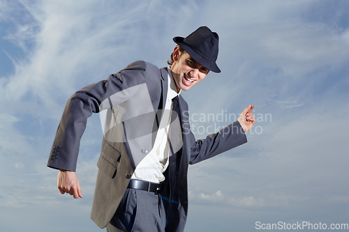 Image of Business man, dancing and sky with suit, happiness and freedom with success, energy or outdoor for celebration. Young entrepreneur, businessman or dancer with excited face, comic and moving by clouds