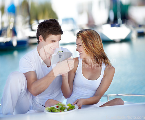 Image of Travel, food and couple on yacht with salad smile on summer holiday, vacation and adventure by sea. Happy, vegan and man and woman eating healthy on luxury cruise for journey, romantic trip and date