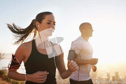 Image of Sunrise, streaming and fitness couple running as workout or morning exercise for health and wellness together. Sport, marathon and woman runner run with man athlete for training for sports or energy