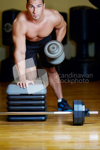 Image of Fitness portrait, dumbbell exercise and man doing power workout, weight lifting or healthy lifestyle routine. Gym studio focus, strong performance and bodybuilder person with muscle weightlifting