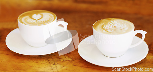 Image of Latte, retro and coffee cup on brown wooden table at a restaurant to drink expresso in the kitchen. Cafe, coffee and vintage background and espresso aroma with milk and cozy house for breakfast