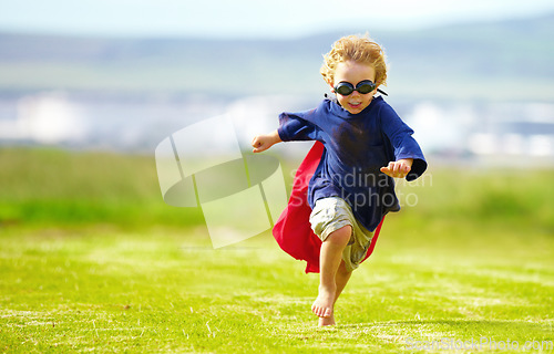 Image of Young boy, costume and running in park, playing and carefree outdoor with happiness or playful child on grass. Freedom, energy or youth and happy kid in cape or goggles fun on green lawn with mockup