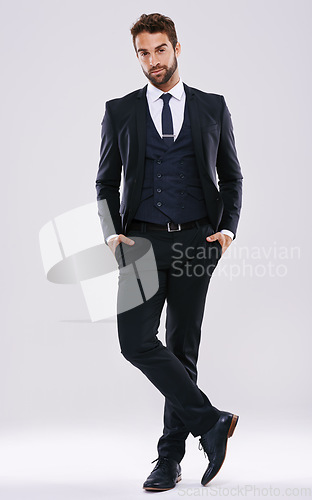 Image of Portrait, suit and man with fashion, confidence and happiness isolated against a studio background. Face, male person and ceo with business mindset, success and pride with stylish clothes and outfit