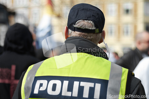 Image of Law enforcement, protection and security with police officer in crowd for peace, safety and authority. Emergency services, justice and guard with back of person in city for rally, order and arrest