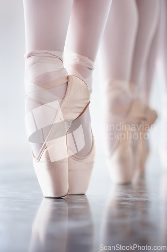 Image of Ballet, dance and shoes with the en pointe feet of a ballerina group in a studio for rehearsal or recital. Creative, stage and theatre production with a dancer closeup training for an artistic show