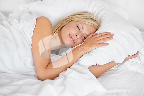 Image of Sleep, relax and comfort with a woman in bed during the morning while in luxury hotel accommodation on vacation. Sleeping, hospitality and rest with a young female person lying in a bedroom at home