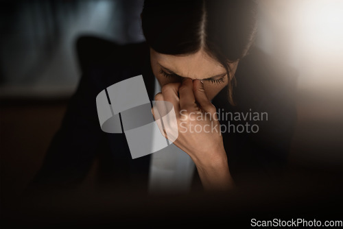 Image of Headache, stressed businesswoman working late at night and overworked in a office. Burnout or mental health, anxiety and female worker in dark workplace tired or frustrated with hand by face.
