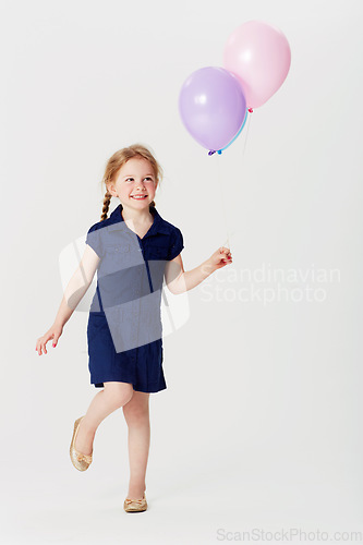 Image of Smile, balloons and girl playing in studio isolated on a white background mockup space. Happiness, air balloon and kid play games with inflatable toys, having fun and enjoying birthday celebration.