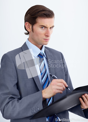 Image of Business, writing or portrait of angry man with document warning in studio for compliance, complaint or white background. Face, Hr or annoyed person with paperwork for workplace accountability review