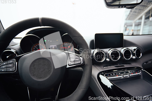 Image of Control buttons on steering wheel. Car interior.