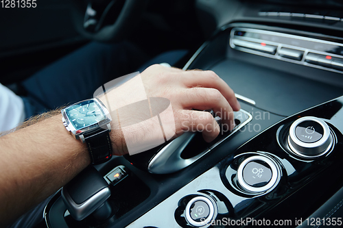 Image of hand on automatic gear shift, Man hand shifting an automatic car