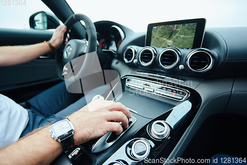 Image of hand on automatic gear shift, Man hand shifting an automatic car