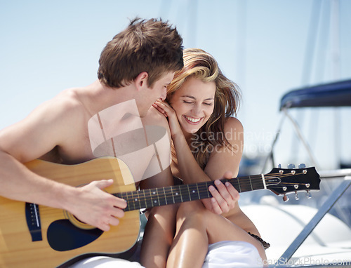 Image of Guitar, yacht and couple on romantic date feeling happy, excited and with love together at the beach or sea. Luxury, music and man singing for a woman while bonding on summer vacation or holiday