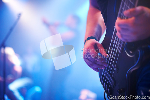 Image of Guitar, music festival and man with a band on stage for a show, performance or night event. Party, rock and hands of a guitarist on an electric instrument for a concert, musician and entertainment