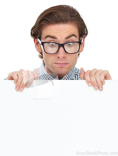 Image of Looking, shocked and man with poster for mockup in studio isolated on a white background. Board, surprised and male person, geek or nerd with copy space for advertising, marketing or promotion banner