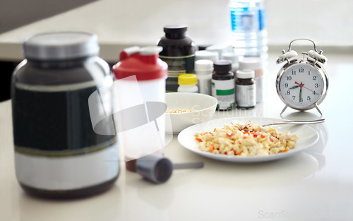 Image of Table closeup, food and supplement in kitchen for health, diet goal or schedule in home with clock. Meal plan, watch and planning for cooking, preparation or nutrition with drugs, lunch or breakfast