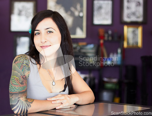 Image of Tattoos, portrait or woman with arm sleeve of art design, edgy or unique creative style in a shop. Identity, tattoo artist or cool female person with funky ink on skin for creativity or expression