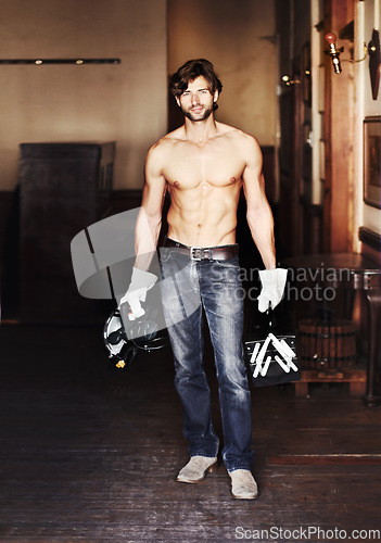 Image of Portrait, diy and a handsome shirtless handyman holding equipment indoor for home improvement. Maintenance, renovation and service with a sexy male construction worker standing topless in a house