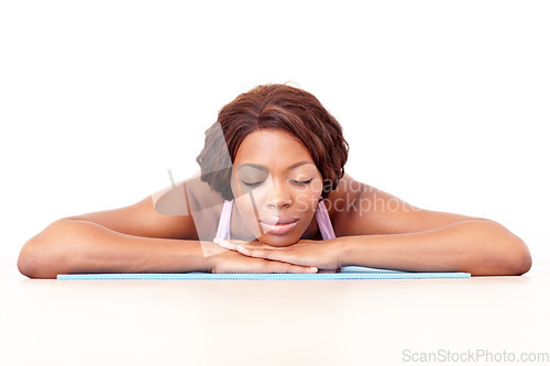 Image of Restful. Woman, studio floor and yoga with sleep, peace and zen for wellness, training and mindfulness by white background. Isolated african lady and sleeping on mat for calm, relax and meditation.