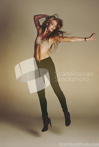 Image of Dance jump, woman and portrait of a young dancer model with casual fashion and confidence. Isolated, studio background and dancing pose of a female person with youth, body freedom and natural beauty