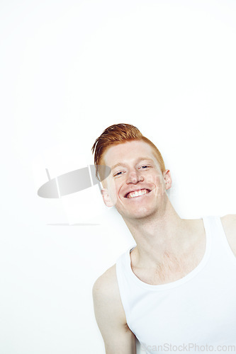 Image of Portrait, smile and face of a man in studio with a smile, happiness and a positive attitude. Unique male model person with ginger or red hair isolated on a white background with mockup space