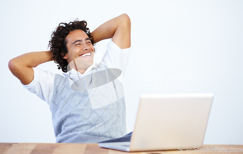 Image of Relax, laptop and businessman laughing after he complete a task isolated in a white background and an office desk. Calm, finish and male employee or worker smile and rest at work in a company