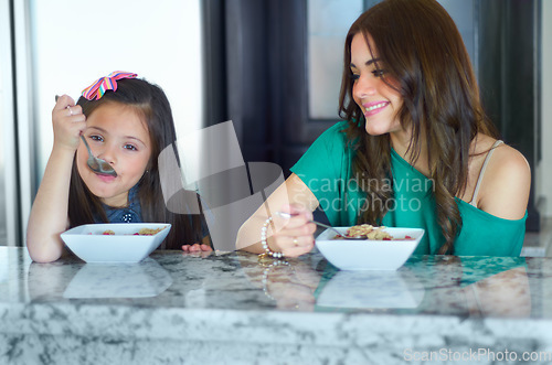 Image of Young mother, breakfast portrait and child and happy girl or young people eating cereal, morning food or meal. Home, kids and family or parent enjoy bonding time together at kitchen table