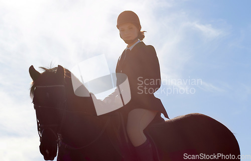 Image of Equestrian, lens flare and portrait of woman on horse for competition, training and show. Performance, riding and fitness with female jockey on stallion for animal, athlete and contest event