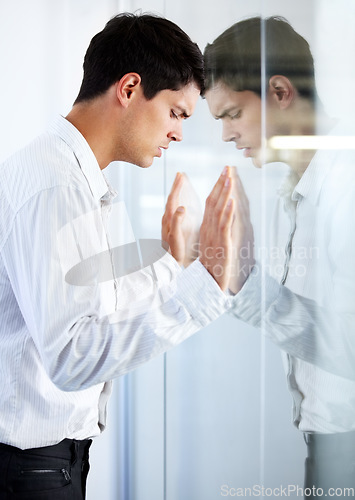 Image of Work, thinking and a man at a window with stress, corporate burnout and tired with reflection. Anxiety, depression and a businessman looking depressed or frustrated while working in the office