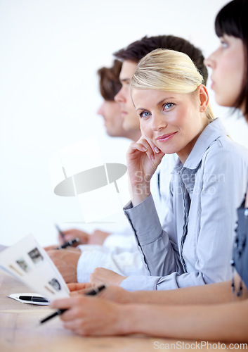 Image of Portrait, meeting and a business woman in the boardroom during a strategy or planning workshop. Corporate, professional and seminar with a young female employee sitting at a table in the office