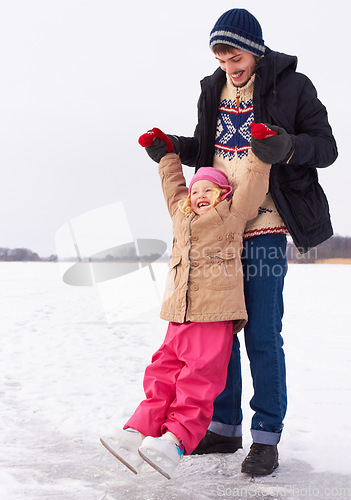 Image of Man with girl outdoor, learn to ice skate and fun in nature with snow, sports and recreation. Father spending quality time with daughter, teaching and learning skating on frozen lake during winter