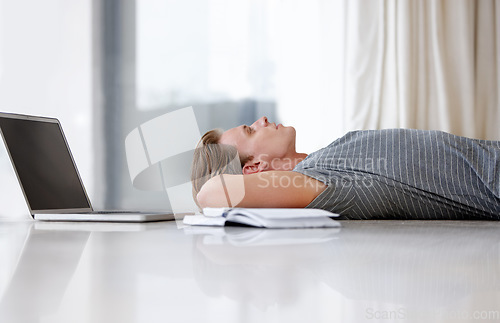 Image of Laptop, thinking and man student on floor with books for planning, project ideas and future brainstorming. Education, knowledge and male person with textbook and computer for online learning at home