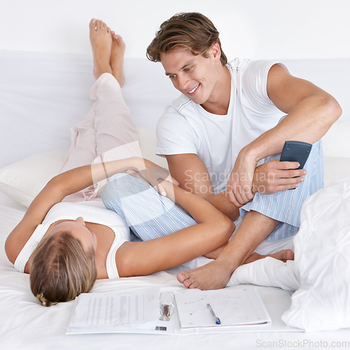 Image of Man, woman and bedroom with calculator, budget and planning finance for saving, investment or debt in home. Couple, tax and happiness for profit, bonus and conversation for future, goals and notebook