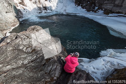 Image of Happy woman relaxing on the top of mountain