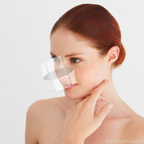 Image of Skincare, thinking and woman touch face in white background, isolated studio and natural beauty. Female model, facial glow and makeup cosmetics for aesthetic dermatology, self love and transformation