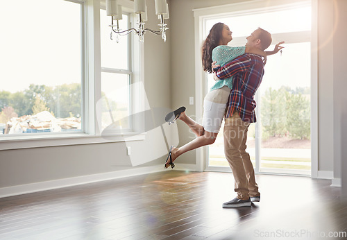 Image of Happy couple, moving into their new home and hug for mortgage or property buy or together in empty lounge and romance. Real estate, man and woman excited or embrace and romance in the living room