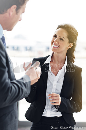 Image of Business, man and woman in a lobby, talking and planning in the workplace, discussion and brainstorming. Employees, male manager and happy female consultant with happiness, share ideas and teamwork