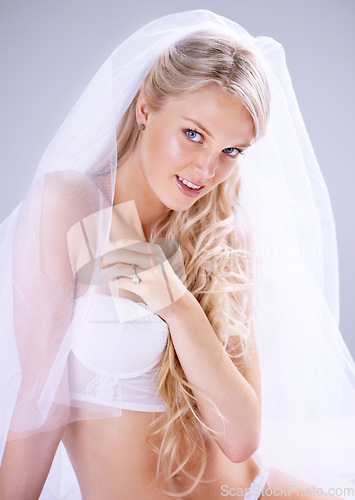 Image of Portrait, wedding and young bride in bra or with lace veil for .lingerie or makeup and hairstyle. Happy, newlywed and woman with diamond ring or underwear ready for marriage in grey background