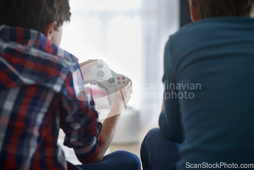 Image of Boys playing video game, controller and friends gaming with technology, esports and entertainment with back view. Gamer kids play games on console at home, youth and male children have fun together