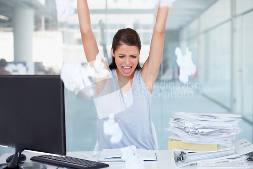 Image of Business woman, stress and throwing paper in air for workload by office desk. Angry, upset or frustrated female employee overworked or under pressure with documents and paperwork at the workplace