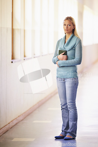 Image of Portrait, woman and teacher in a hallway, standing and education with knowledge in a school. Face, female person and educator in a lobby, serious and teaching with confidence, growth and mindset