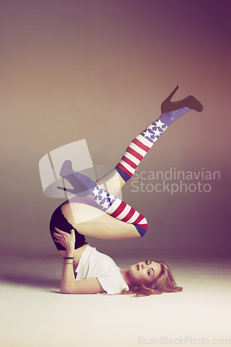 Image of Woman, usa socks and portrait of a model with flag fashion and legs in air in studio. Isolated, female person and gen z clothes with youth and pose with american and patriotic aesthetic