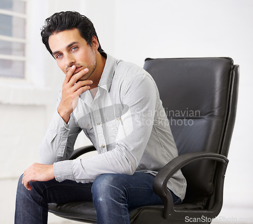 Image of Portrait, business or man on chair in office thinking with pride for career, job or work. Professional, male entrepreneur and serious decision or employee, ceo or person sitting in startup workplace