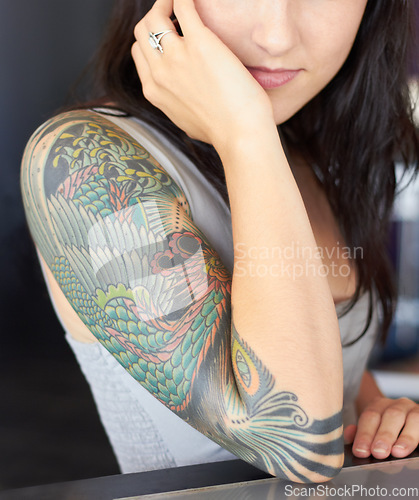 Image of Tattoo, punk and woman arm with art design and unique creative style isolated in a black background. Identity, graphic and artistic female person or artist with ink on her skin for creativity