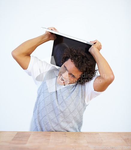 Image of Angry, laptop and frustrated businessman smash his computer due to stress isolated in a white studio background. Anxiety, depression and male employee destroy equipment due to 404, glitch or error