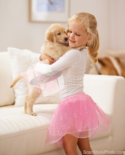 Image of Golden retriever, hug and child happy together with love, care and development. Cute girl kid and animal puppy or pet in a tutu playing dress up as friends on the home sofa with happiness and trust