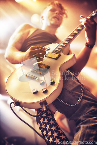 Image of Guitar, man and stage for rock concert, performance and singing at party, event and celebration in night. Male musician, artist or rockstar with instrument at music festival for art, sound and career