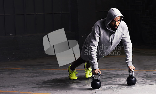 Image of Kettlebell training, mockup and a man athlete during his workout for strength while looking serious. Fitness, focus and weightlifting with a male bodybuilder in a dark studio for physical exercise