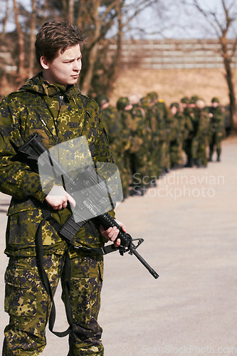 Image of Army, military and soldier with a gun on a battlefield ready for war, fight or mission with courage and loyalty to a country. Hero, outdoor and man professional in service holding a rifle in gear